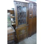 An oak freestanding corner cabinet