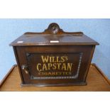 An oak smokers cabinet, bearing Will's Capstan Cigarettes inscription to the door