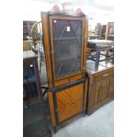 An inlaid mahogany freestanding corner cabinet