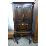 A Jacobean Revival oak geometric moulded corner cupboard on stand