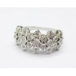 A silver ring set with three rows of diamonds, S