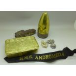 A Christmas 1914 tin, a piece of shrapnel, bomb fuse, badges and a HMS Andromeda naval band