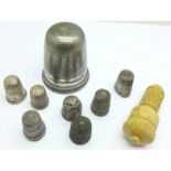 Eight thimbles, including five silver, (three a/f), a part needle holder and a large novelty thimble