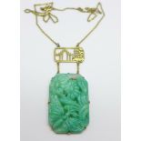 A Chinese carved jade necklet on a plated chain, 39mm x 26mm