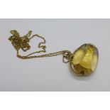 A yellow metal and citrine set swivel fob or pendant on a 9ct gold chain