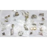 Twenty-five pairs of silver earrings