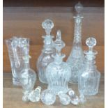 Five glass decanters, a glass water jug with inscription and other glass stoppers