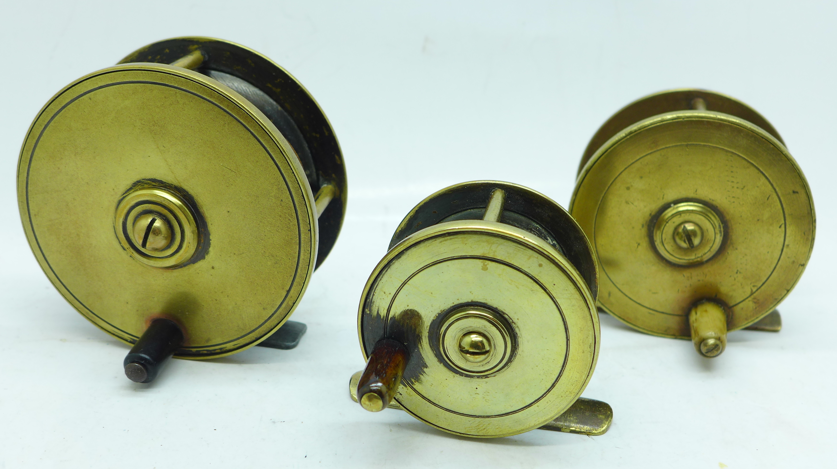 Three brass fishing reels