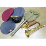 Military items; two berets, peaked cap, bugle and a trench spade