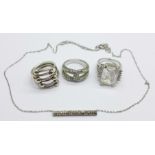 A Fossil barrel pendant on chain, a silver ring and two other dress rings, (4)