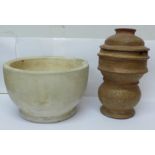 A large mortar and a lidded unglazed jar, possibly for steaming rice