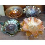 Seven carnival glass dishes including green with butterfly decoration