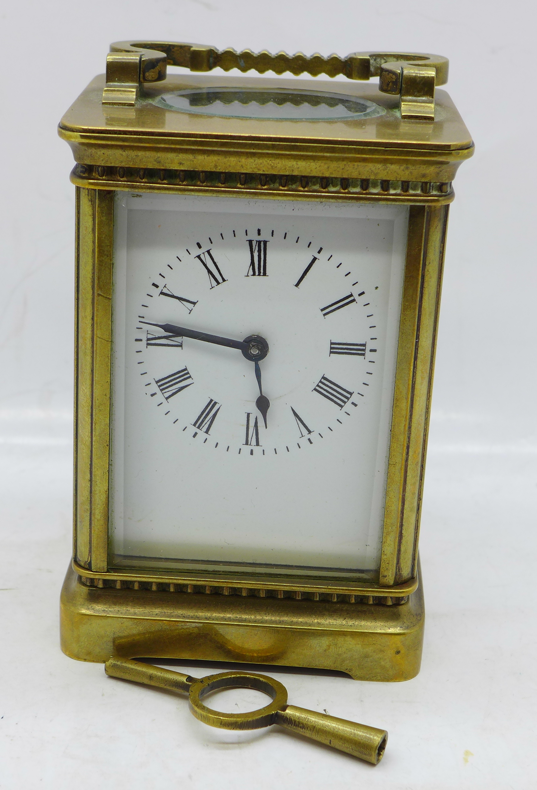 A French brass cased carriage clock with key