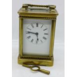 A French brass cased carriage clock with key