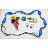 Jewellery; two silver rings, a glass pendant, two brooches and a necklace