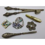 A pair of silver handled tweezers, a pair of silver handled glove stretchers, a silver and mother of