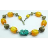 A necklace set with turquoise and marble effect amber coloured beads