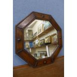 An oak octagonal framed mirror