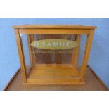 An oak counter top shop shop cabinet, bearing H. Samuel inscription to glass