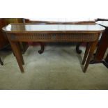 A carved oak demi-lune hall table