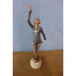 An Art Deco painted spelter figure of a lady, on onyx and marble socle
