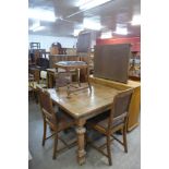 An oak draw-leaf dining table and four chairs