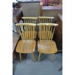 A set of four beech stickback chairs