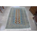 An Afghan hand knotted green ground rug, 190 x 132cms