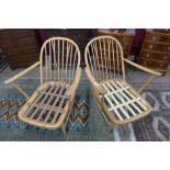 A pair of Ercol blonde low armchairs