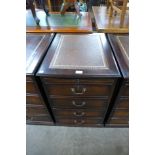 A mahogany and leather topped filing cabinet