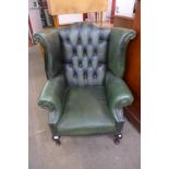 A Chesterfield green leather wingback armchair