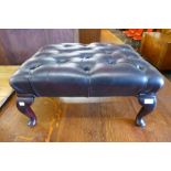 A red leather footstool