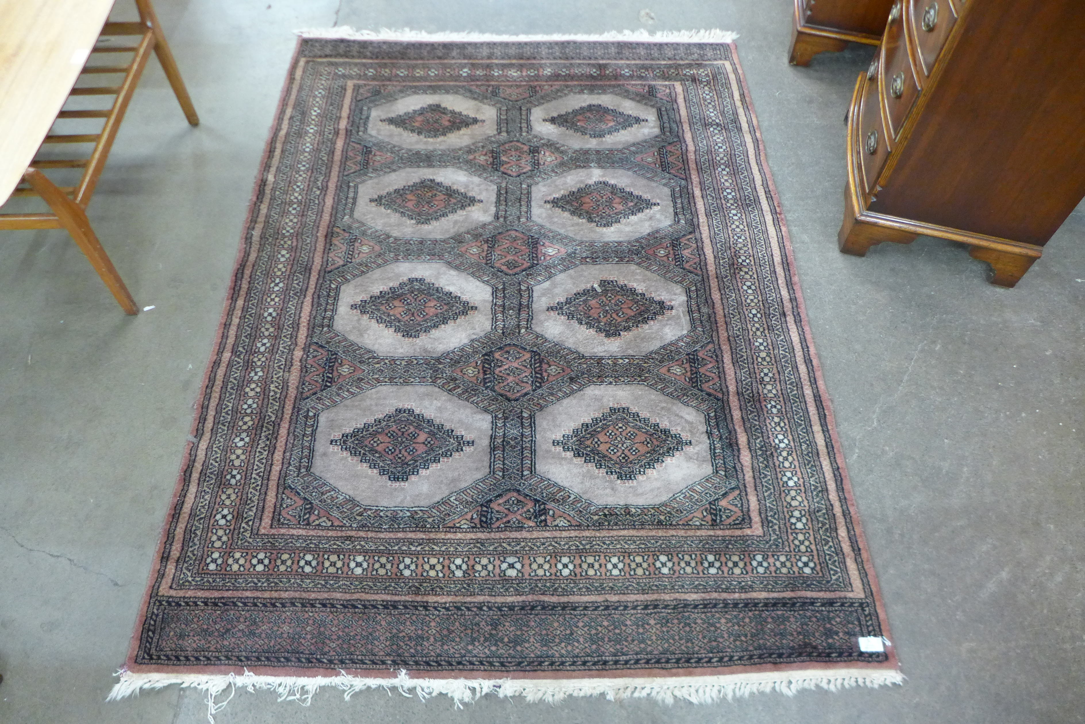 An eastern terracotta ground rug, 174 x 126cms