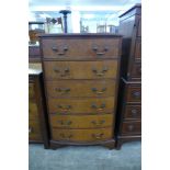 A walnut bow front chest of drawers