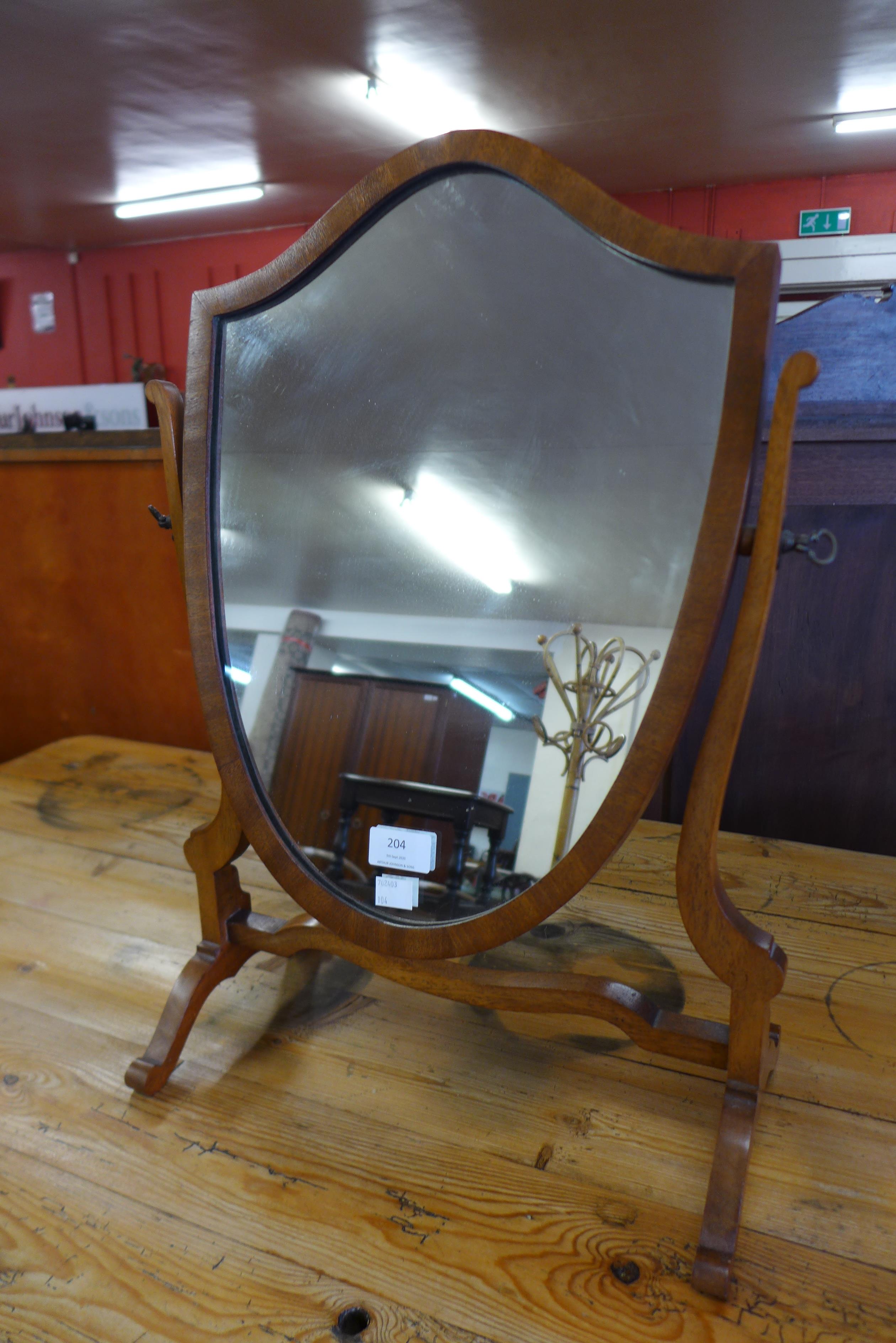 A mahogany shield shape toilet mirror
