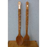 A large carved wood spoon and fork