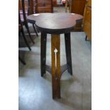 An Arts and Crafts oak trefoil top occasional table
