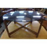 A teak and glass topped circular coffee table