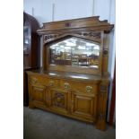 An Arts and Crafts carved oak mirrorback sideboard