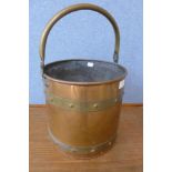 An Arts and Crafts brass and copper coal bucket