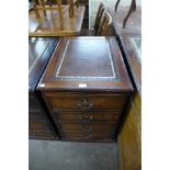 A mahogany and leather topped filing cabinet