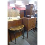 A small mahogany bow front chest of drawers, a hall table and a cocktail cabinet