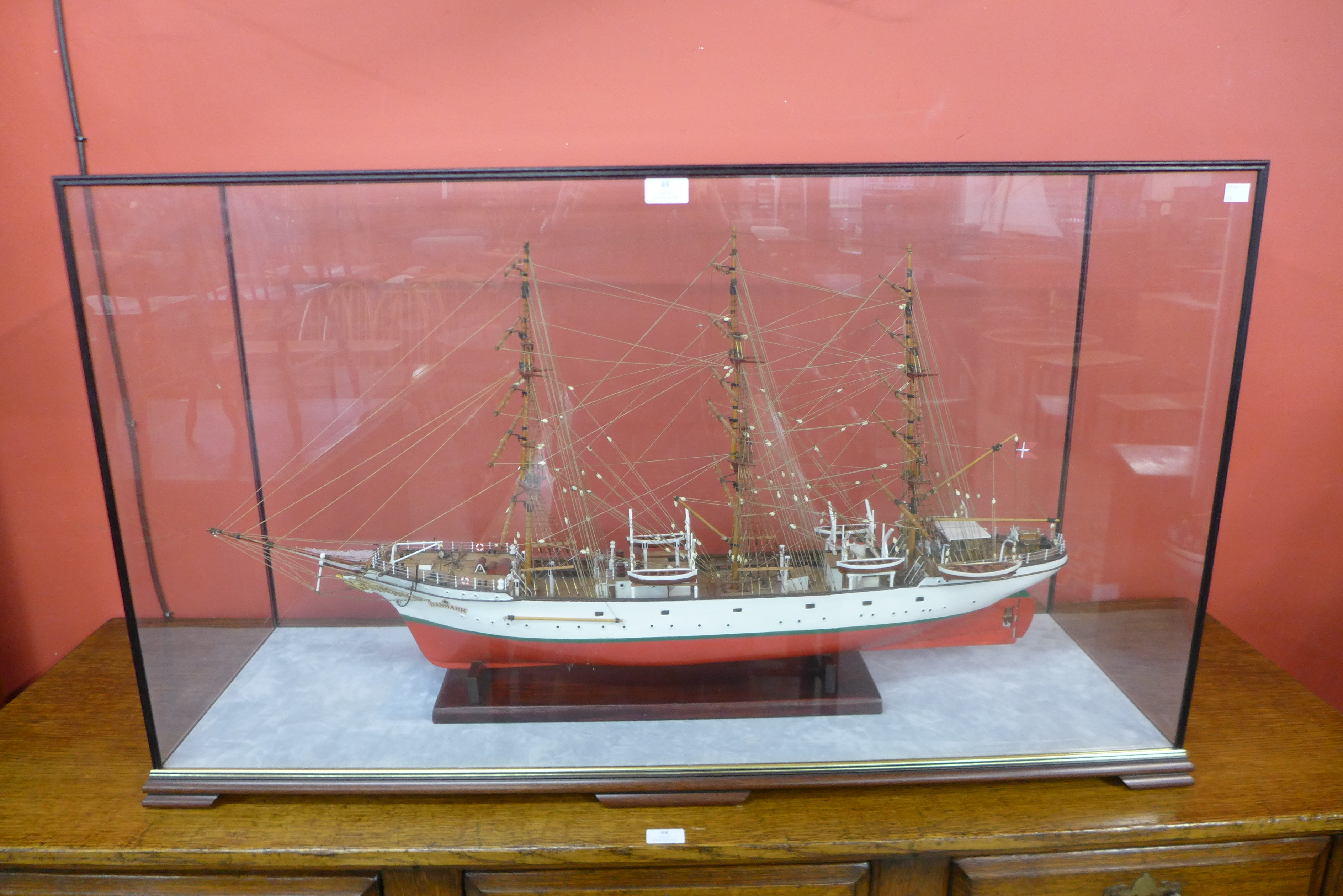 A Danmark model three mast ship, cased, 65cms h, 113cms w, 36cms d