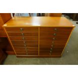 A teak chest of drawers