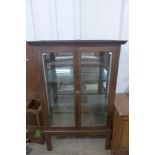 An early 20th Century oak shop display cabinet