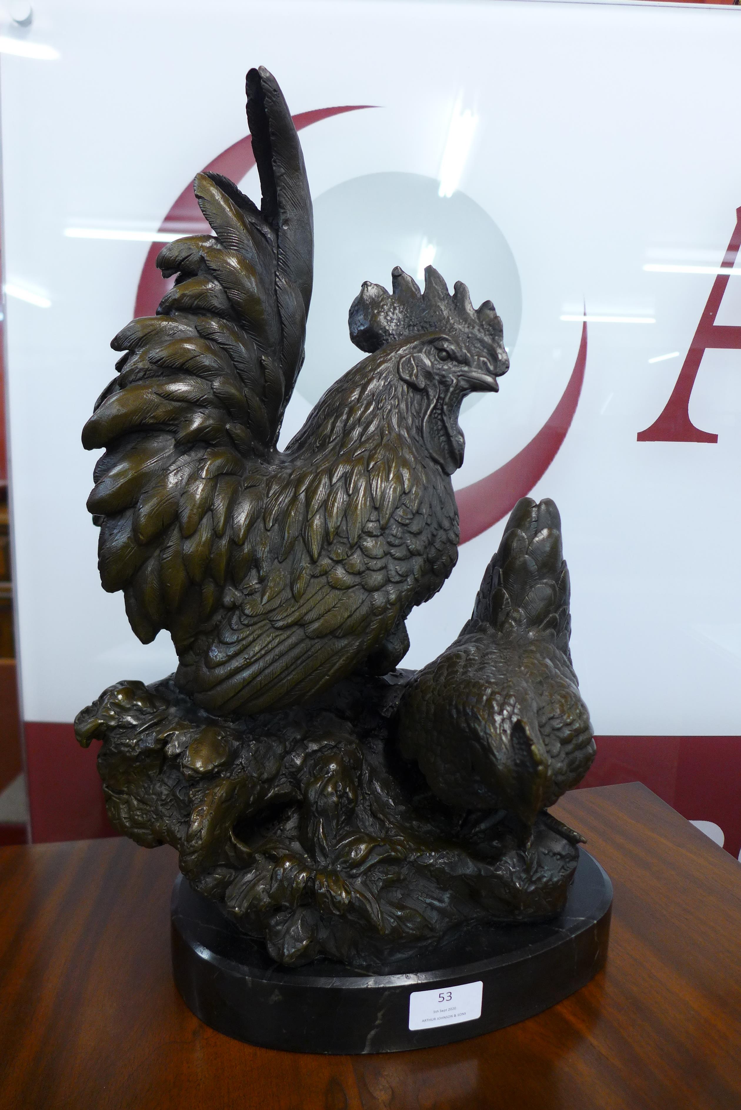 A large bronze figure of bantam chickens, on black marble plinth, 48cms h