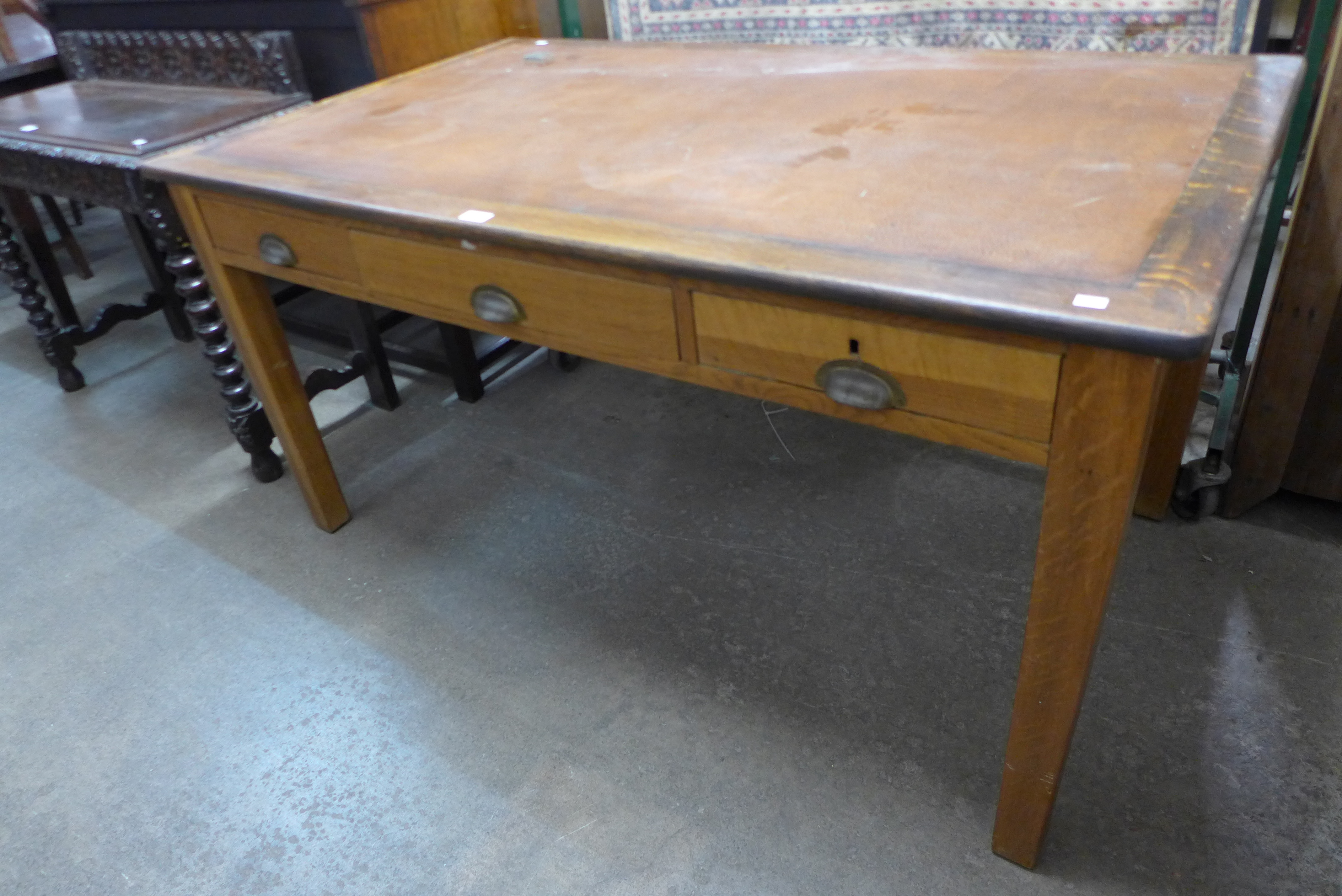 An early 20th Century oak three drawer library desk