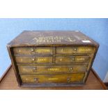 A pine haberdashery counter top shop cabinet, bearing Clark & Co Anchor Mills painted inscription,