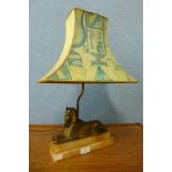 An Art Deco Egyptian Revival sphinx table lamp, on alabaster base