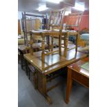 An oak draw-leaf table and four chairs